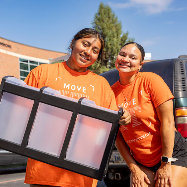 Students moving in with dorm furniture